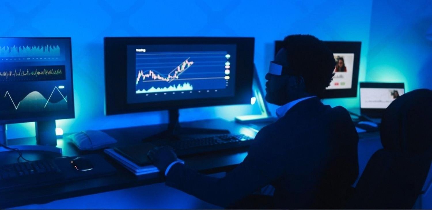 Analyst at a multi-monitor workstation in a dark Dubai office